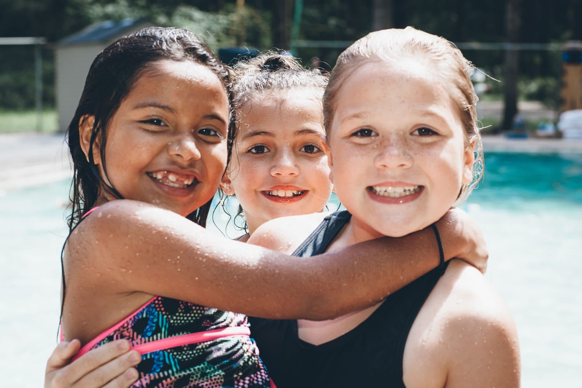 Three girls hugging